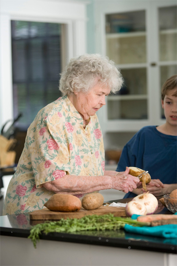 Grandmother doing something in kitchen